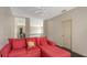 This bright bonus room features neutral walls, plush red seating, and views of the upstairs hallway and beyond at 6905 Pine Valley St, Bradenton, FL 34202