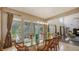 Dining area boasts a glass table and direct access to a screened outdoor pool and seating area at 6905 Pine Valley St, Bradenton, FL 34202