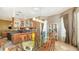 Bright dining room with a glass table, contemporary lighting, and custom cabinetry for elegant dining at 6905 Pine Valley St, Bradenton, FL 34202