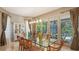 A dining area features a glass table and direct access to a screened outdoor pool and seating area at 6905 Pine Valley St, Bradenton, FL 34202