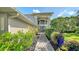 Contemporary home with a stylish entrance, highlighted by modern architecture, stone walkway, and artful landscaping at 6905 Pine Valley St, Bradenton, FL 34202