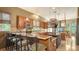Large kitchen with a breakfast bar, granite countertops, and custom wood cabinetry at 6905 Pine Valley St, Bradenton, FL 34202