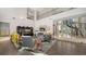 Spacious living room with a spiral staircase, high ceilings, elegant furnishings, and abundant natural light at 6905 Pine Valley St, Bradenton, FL 34202