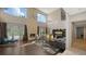 Bright living room with soaring ceilings, stone fireplace, hardwood floors, and expansive windows offering lovely views at 6905 Pine Valley St, Bradenton, FL 34202