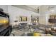 Comfortable living room featuring stylish furniture, a decorative rug, high ceilings, and a view of the upper level at 6905 Pine Valley St, Bradenton, FL 34202