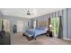 Spacious main bedroom featuring an eye-catching accent wall, ceiling fan, and private access to the screened lanai at 6905 Pine Valley St, Bradenton, FL 34202