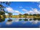 Picturesque view of a pond reflecting the blue sky and puffy white clouds, near the golf course at 6905 Pine Valley St, Bradenton, FL 34202