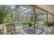 Relax in this screened pool area, which features a see-through roof and plenty of seating for guests at 6905 Pine Valley St, Bradenton, FL 34202