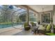 Inviting screened-in lanai featuring a sparkling pool and comfortable seating area, perfect for outdoor relaxation and entertaining at 6905 Pine Valley St, Bradenton, FL 34202
