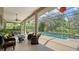 Beautiful screened lanai with a sparkling pool, comfortable seating and ceiling fan for a perfect blend of indoor/outdoor living at 6905 Pine Valley St, Bradenton, FL 34202