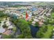 Aerial view of home showcasing a pool, lush landscaping, and beautiful waterfront property in an attractive neighborhood at 7115 39Th E Ln, Sarasota, FL 34243