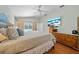 Bright bedroom with a ceiling fan, TV, and a dresser, offering a relaxing retreat at 7115 39Th E Ln, Sarasota, FL 34243