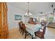 Elegant dining room with chandelier, dining table, and a view into the Gathering room at 7115 39Th E Ln, Sarasota, FL 34243