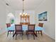 Bright dining room features a wood china cabinet, dining table with seating, and lots of natural light at 7115 39Th E Ln, Sarasota, FL 34243