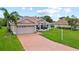 Attractive single-story home features a red tile roof, well-maintained landscaping, and an attached two-car garage at 7115 39Th E Ln, Sarasota, FL 34243