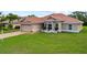 Well-maintained single-story house exhibits a red tile roof, manicured lawn, and an attached two-car garage at 7115 39Th E Ln, Sarasota, FL 34243