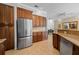 Well-designed kitchen featuring a stainless steel refrigerator, granite countertops, and ample wood cabinetry at 7115 39Th E Ln, Sarasota, FL 34243