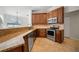Well-equipped kitchen featuring wood cabinets, granite countertops, and stainless steel appliances at 7115 39Th E Ln, Sarasota, FL 34243