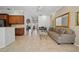 Spacious living room showcases neutral decor, tile floors, and seamless flow to other living spaces at 7115 39Th E Ln, Sarasota, FL 34243