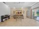 Relaxing living room with neutral decor, piano, glass table, and sliding door access to the outdoor patio at 7115 39Th E Ln, Sarasota, FL 34243
