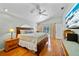 The main bedroom features wood floors and access to the outside screened-in pool area at 7115 39Th E Ln, Sarasota, FL 34243