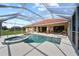 Screened-in pool and spa, offering a relaxing outdoor space with views of the well-manicured lawn at 7115 39Th E Ln, Sarasota, FL 34243