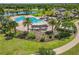 Aerial view of the community pool area with palm trees and ample seating at 7130 Westhill Ct, Lakewood Ranch, FL 34202