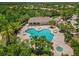Aerial view of the community pool area, surrounded by trees and residential homes at 7130 Westhill Ct, Lakewood Ranch, FL 34202