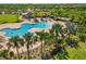 Aerial view of the community pool area featuring winding pool with ample seating and lounging areas at 7130 Westhill Ct, Lakewood Ranch, FL 34202