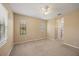 Spacious carpeted bedroom with natural light from windows and ceiling fan at 7130 Westhill Ct, Lakewood Ranch, FL 34202