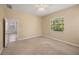 Bedroom with neutral carpet and walls, ceiling fan, and large window view at 7130 Westhill Ct, Lakewood Ranch, FL 34202