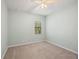Bright bedroom features neutral walls, carpet, ceiling fan, and a window providing natural light at 7130 Westhill Ct, Lakewood Ranch, FL 34202