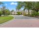 The elegant clubhouse entrance with meticulously manicured landscaping and a circular driveway provides a grand welcome at 7130 Westhill Ct, Lakewood Ranch, FL 34202