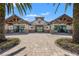 Clubhouse entrance featuring manicured landscaping at 7130 Westhill Ct, Lakewood Ranch, FL 34202