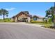 A spacious, well-maintained clubhouse features architectural details, lush landscaping, and a welcoming entrance for residents at 7130 Westhill Ct, Lakewood Ranch, FL 34202