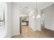 Open dining area with modern lighting and views into the kitchen at 7130 Westhill Ct, Lakewood Ranch, FL 34202