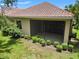 Back exterior shot of the property highlighting the patio, yard, and unique tile roof at 7130 Westhill Ct, Lakewood Ranch, FL 34202