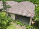 Back exterior shot of the property highlighting the patio, yard, and unique tile roof at 7130 Westhill Ct, Lakewood Ranch, FL 34202