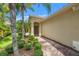 Inviting front entrance with a brick pathway and lush landscaping at 7130 Westhill Ct, Lakewood Ranch, FL 34202