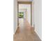 Long hallway featuring tiled flooring, neutral walls, and natural light at 7130 Westhill Ct, Lakewood Ranch, FL 34202