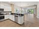 Open kitchen with stainless steel appliances, granite counters, and seamless flow to the living area at 7130 Westhill Ct, Lakewood Ranch, FL 34202