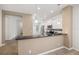 Modern kitchen featuring stainless steel appliances, white cabinetry, and a sleek countertop bar at 7130 Westhill Ct, Lakewood Ranch, FL 34202