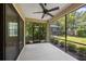 View of the screened-in lanai with ceiling fan, looking out on the pool and green backyard at 7130 Westhill Ct, Lakewood Ranch, FL 34202