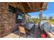 Outdoor dining area with built-in grill, stone accents, and TV at 7130 Westhill Ct, Lakewood Ranch, FL 34202