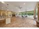 Spacious outdoor patio with barstool seating, fireplace and ceiling fans for relaxation at 7130 Westhill Ct, Lakewood Ranch, FL 34202