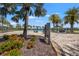 Community pool area surrounded by lush landscaping and palm trees at 7130 Westhill Ct, Lakewood Ranch, FL 34202