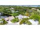Aerial view of a charming home, pond, and lush greenery in a serene neighborhood setting at 7615 4Th Avenue Nw Dr, Bradenton, FL 34209
