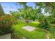 Manicured backyard features a large shade tree and colorful landscaping at 7615 4Th Avenue Nw Dr, Bradenton, FL 34209