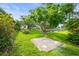 Manicured backyard features a large shade tree and colorful landscaping at 7615 4Th Avenue Nw Dr, Bradenton, FL 34209
