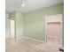 Bedroom featuring light laminate flooring, a ceiling fan, and a walk-in closet at 7615 4Th Avenue Nw Dr, Bradenton, FL 34209